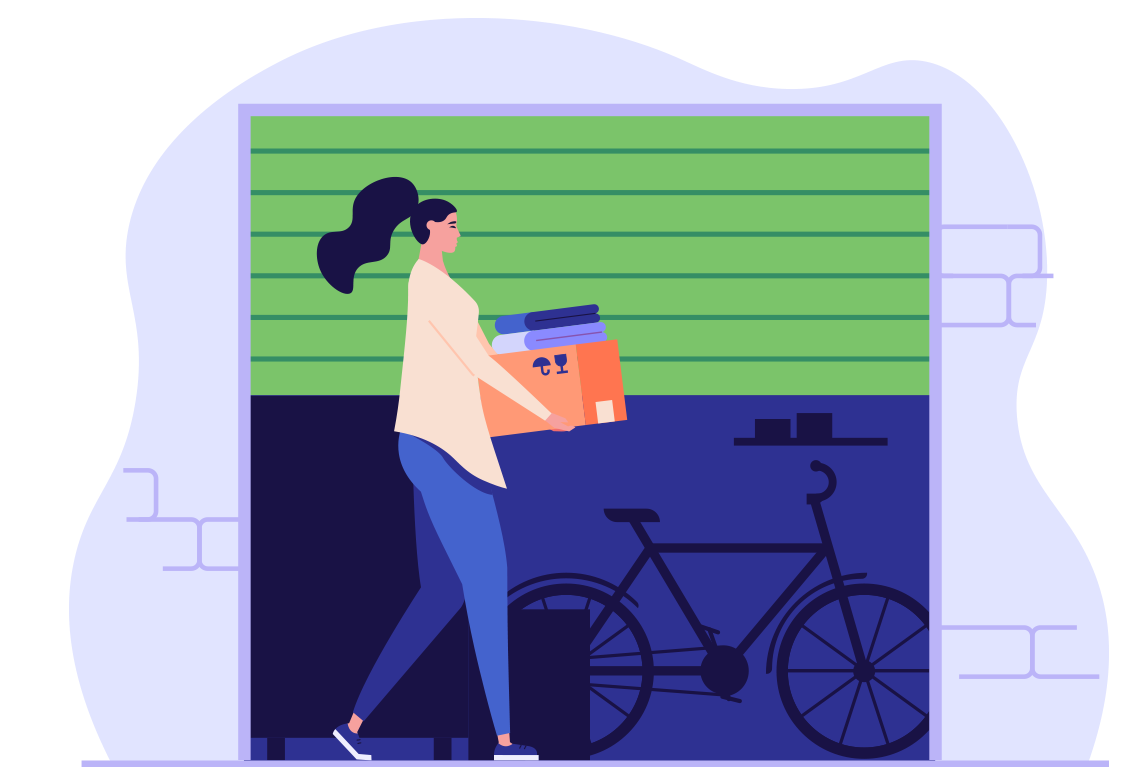 A woman is carrying boxes into a garage next to a bicycle.