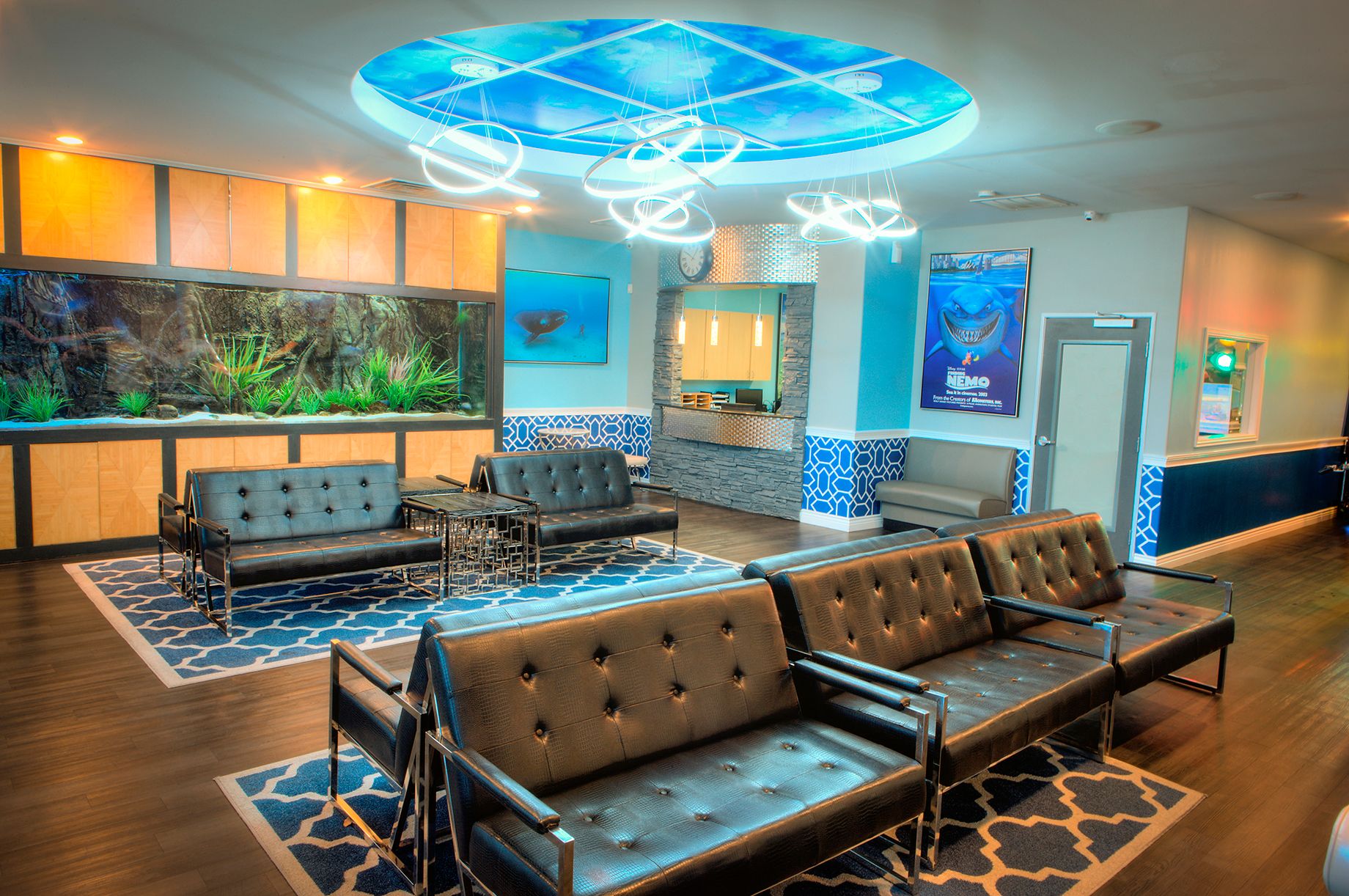 Aqua Dental and Orthodontics in Duncanville, TX. A waiting room with a couch , chairs and an aquarium.
