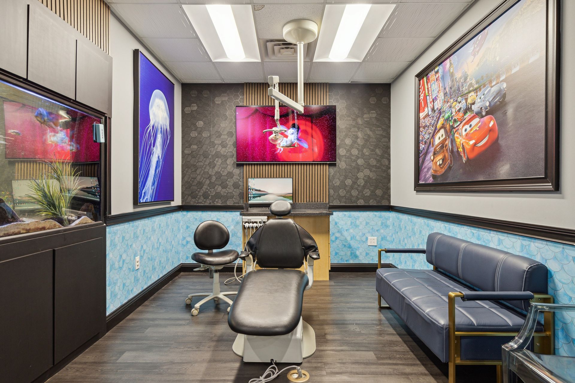 Aqua Dental and Orthodontics in Duncanville, TX. A dental office with a dental chair , couch , and television.