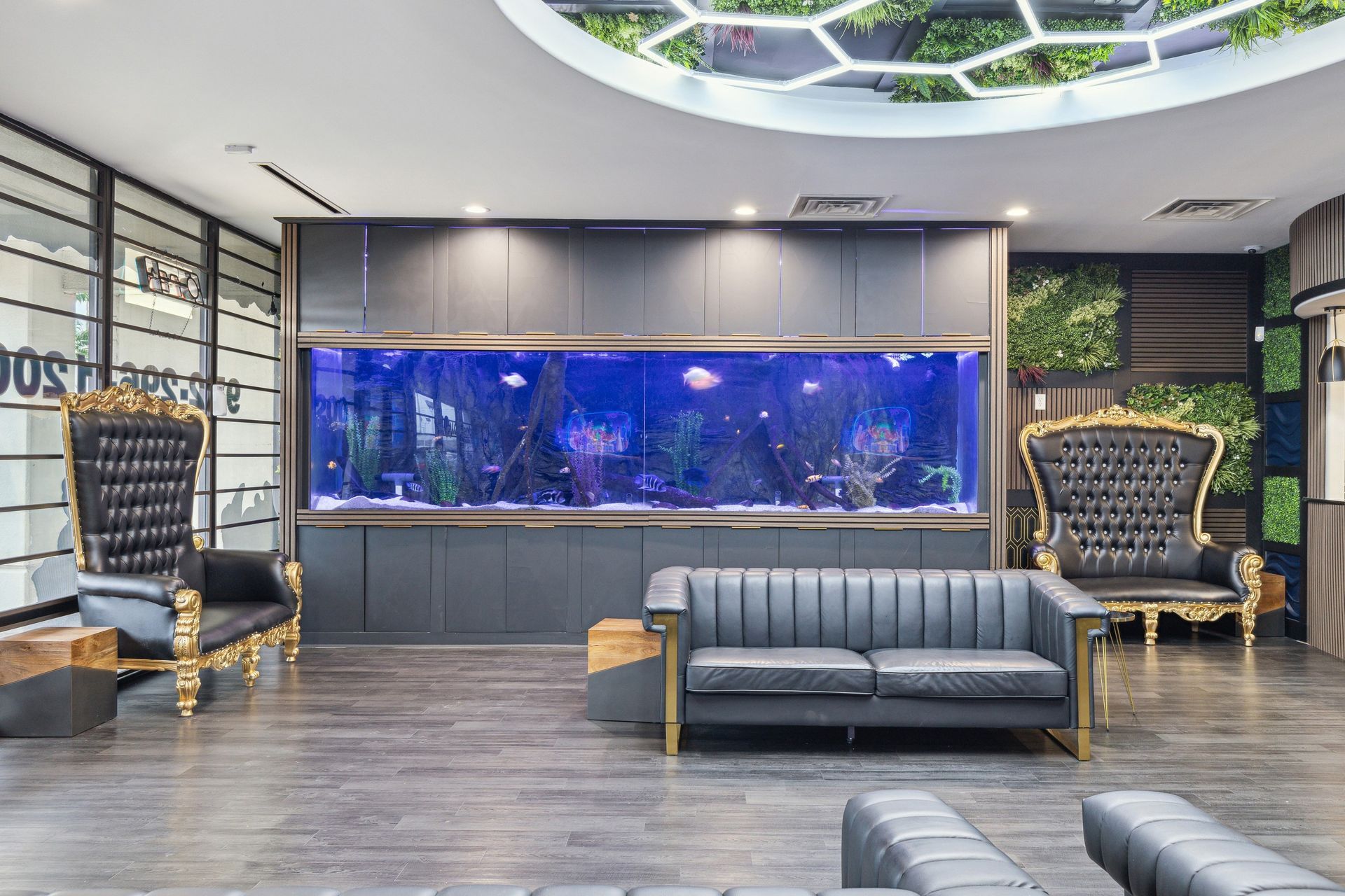 Aqua Dental and Orthodontics in Duncanville, TX. A living room with a couch , chairs , and a large aquarium.
