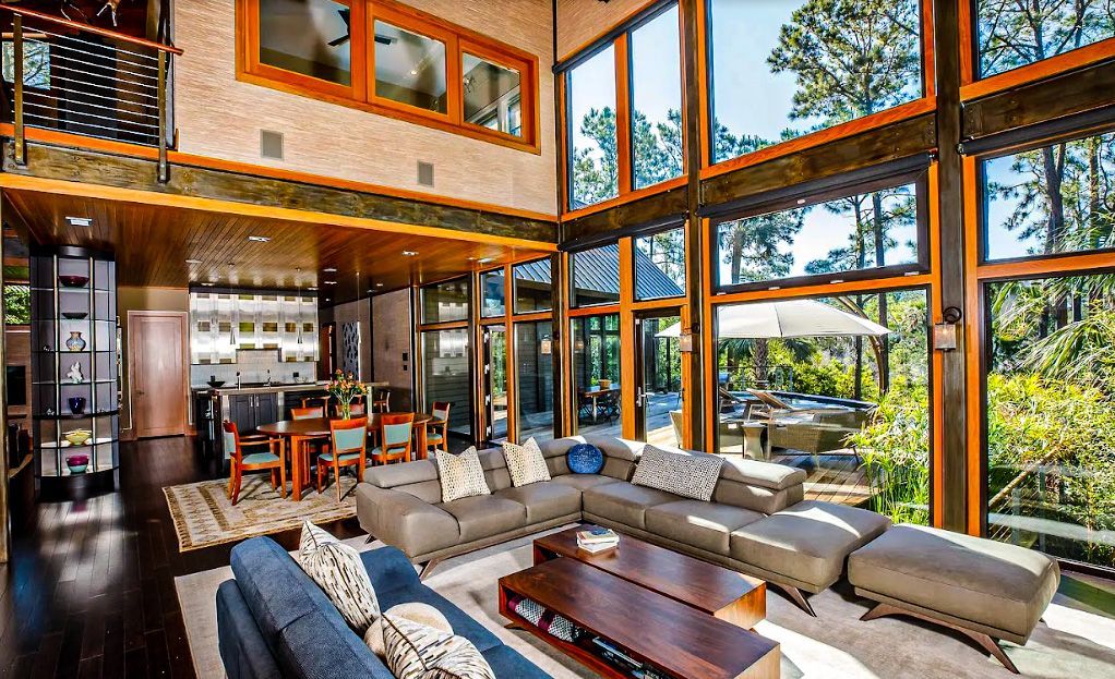 A living room filled with furniture and lots of windows.