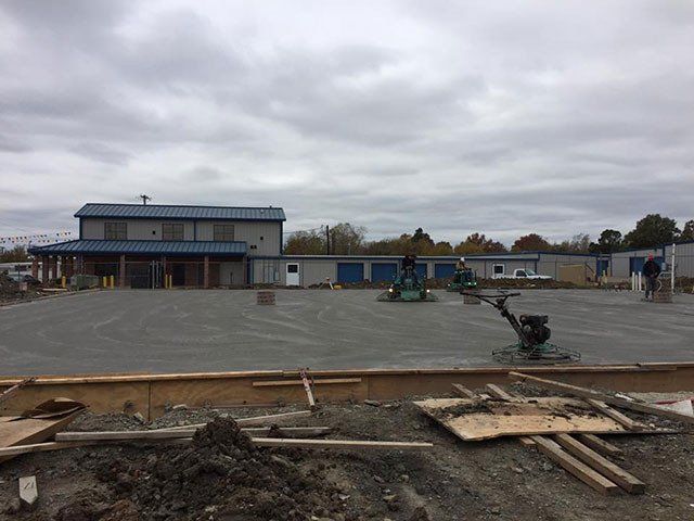 A construction site with a building in the background.