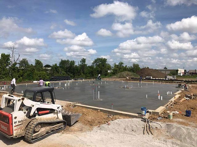 A bulldozer is parked in the middle of a construction site.