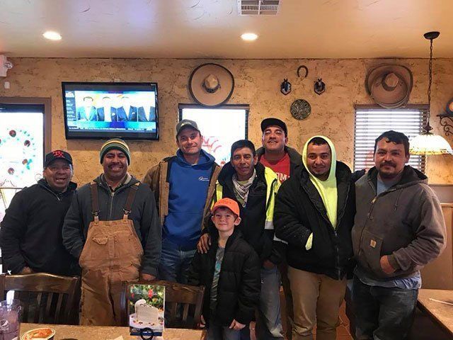 A group of men are posing for a picture in a restaurant.