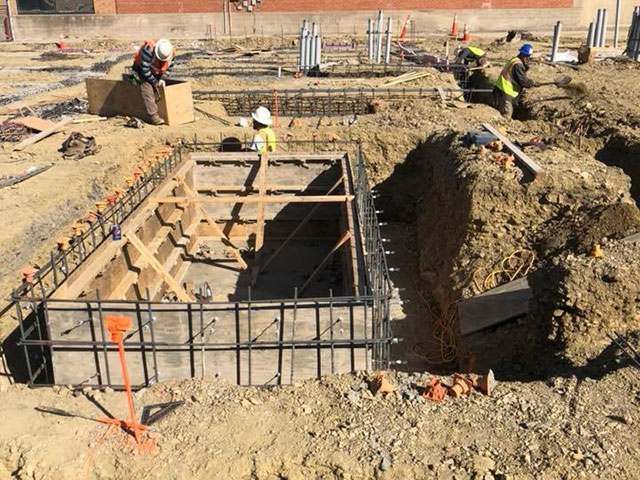 A group of construction workers are working on a construction site.
