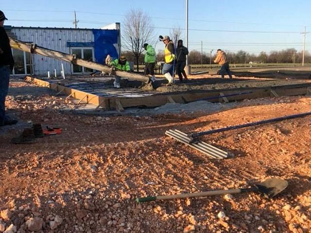 A group of construction workers are working on a construction site.