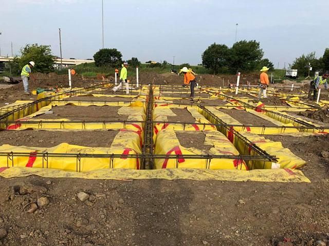A group of construction workers are working on a construction site.