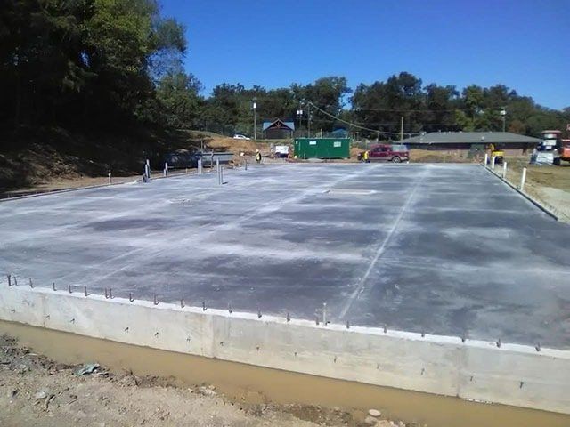 A concrete foundation is being built on a sunny day
