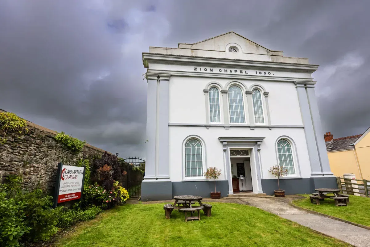 a white building with a sign that says zion chapel 1890