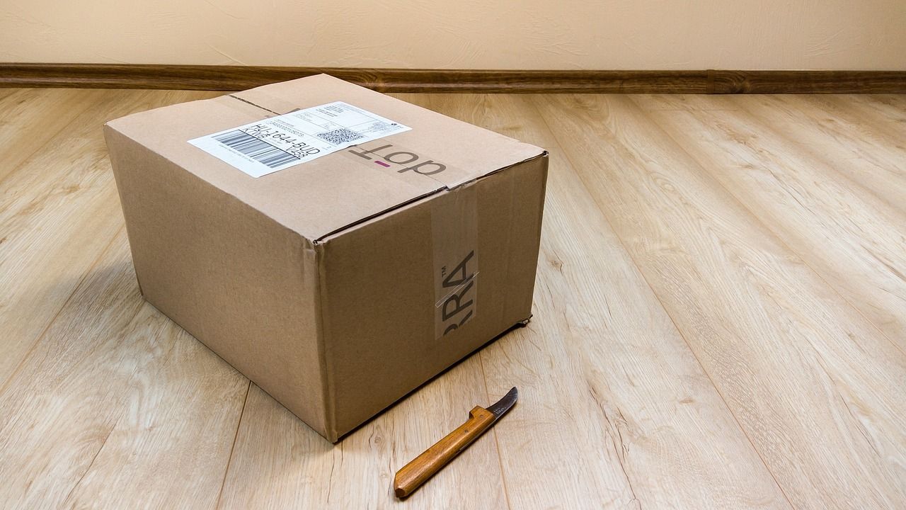 Box on the floor with knife beside it
