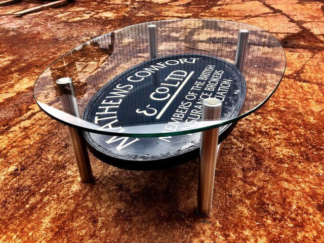 Glass and stainless table to complement an old sign