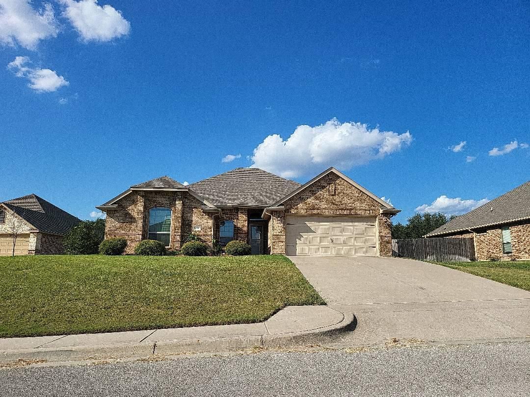 A large house with a lot of grass in front of it.