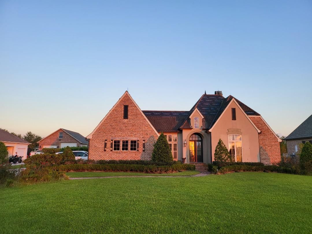 A large house with a large lawn in front of it.