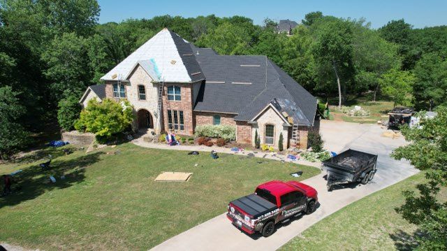 An aerial view of a house with a truck parked in front of it.