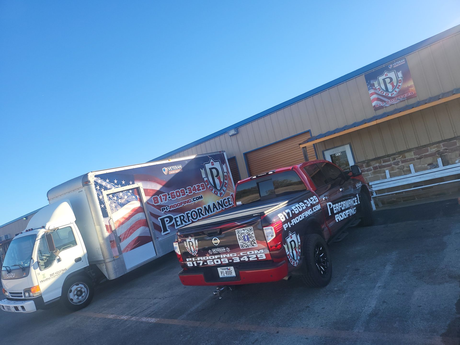 A red truck is parked in front of a building