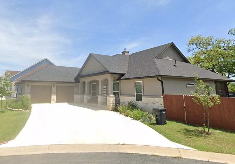 A large house with a driveway leading to it