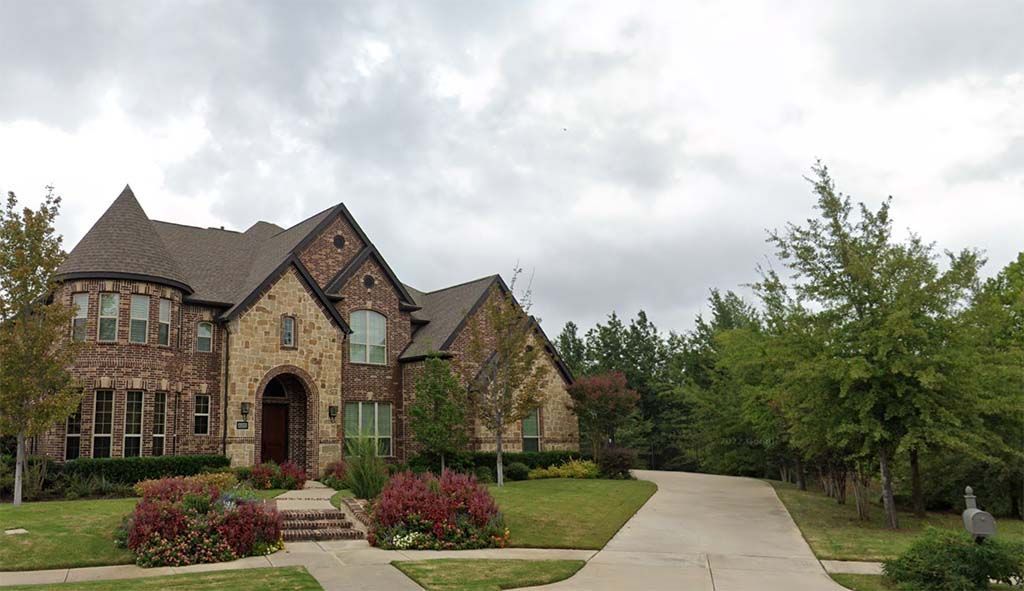 A large house with a driveway leading to it