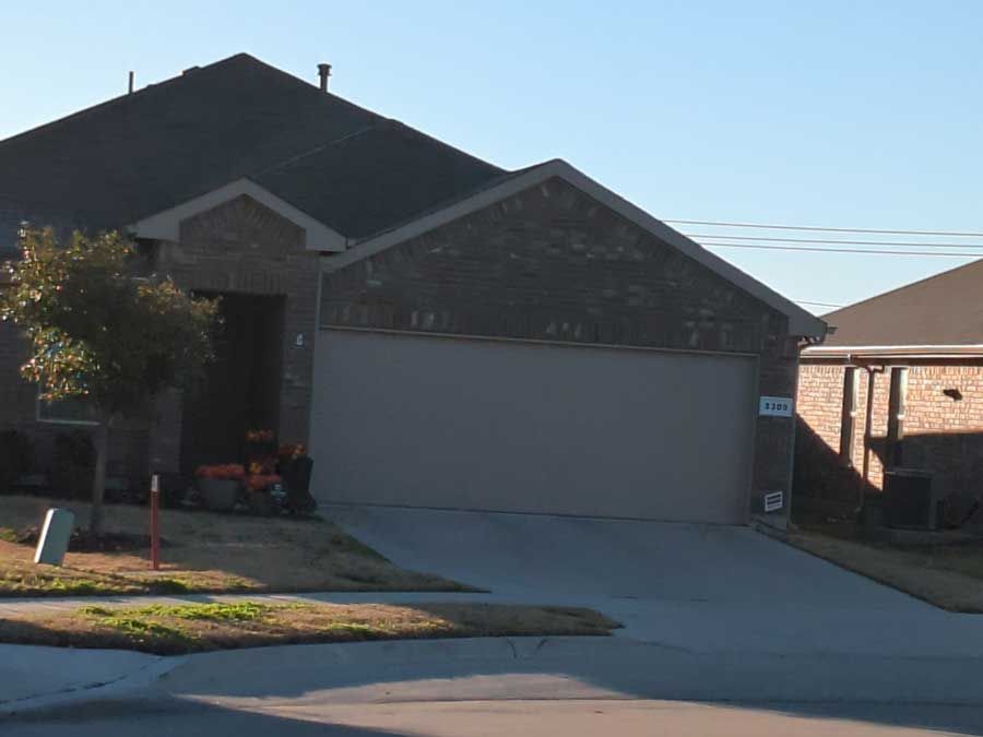 A house with a garage and a sign that says no parking