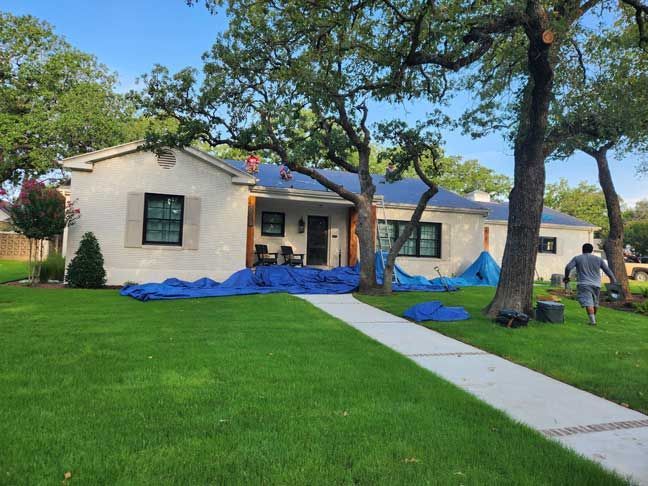 A man is working on the roof of a house.