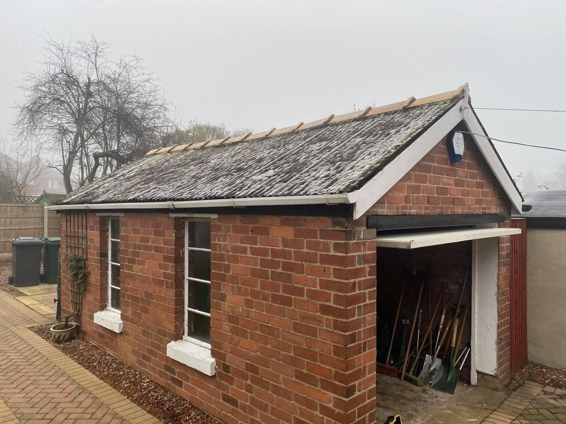 Pebble dashed garage with asbestos roof