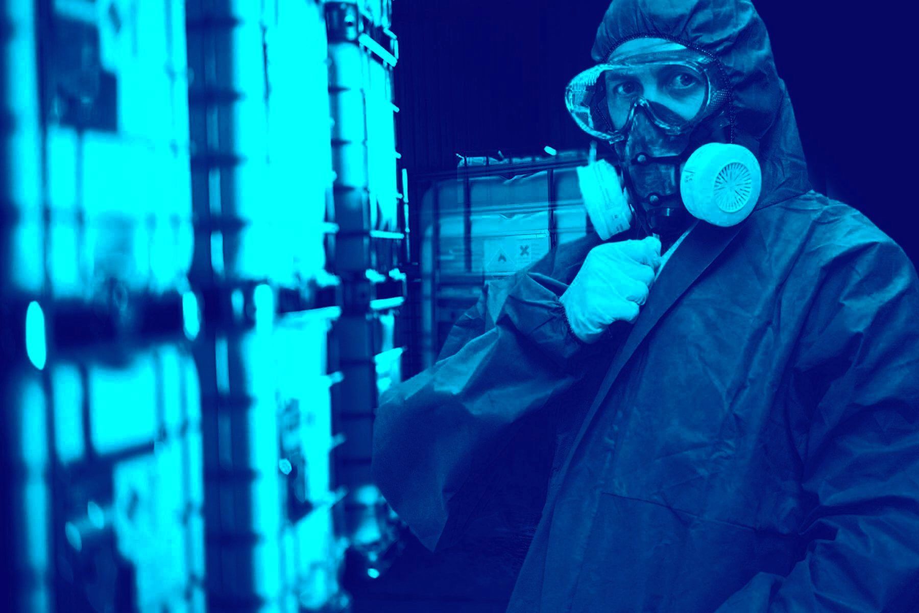 Man in a protective suit, wearing a mask