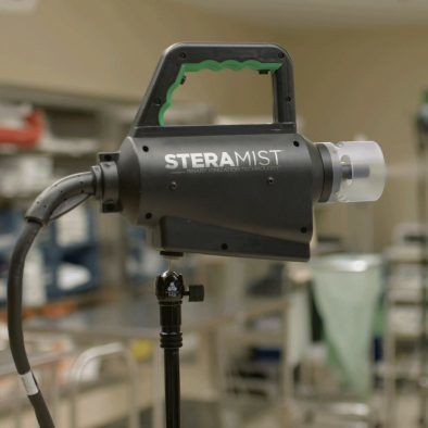 A steramist sprayer is sitting on a stand in a room.