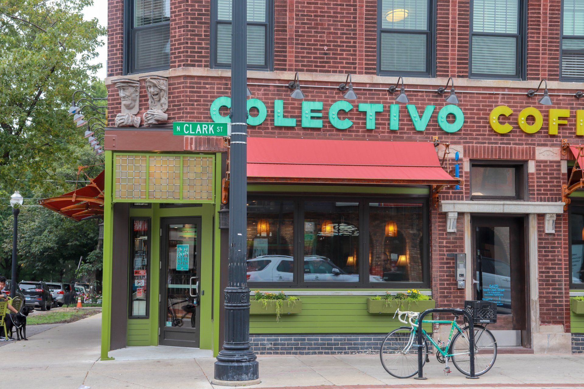 A bicycle is parked in front of the colectivo coffee shop.
