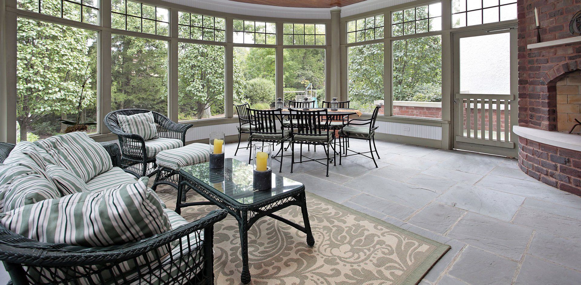 A living room with a lot of windows and a fireplace