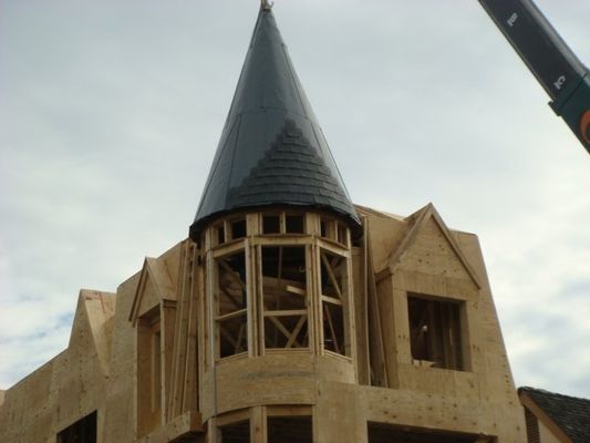 A large wooden building under construction with a steeple on top