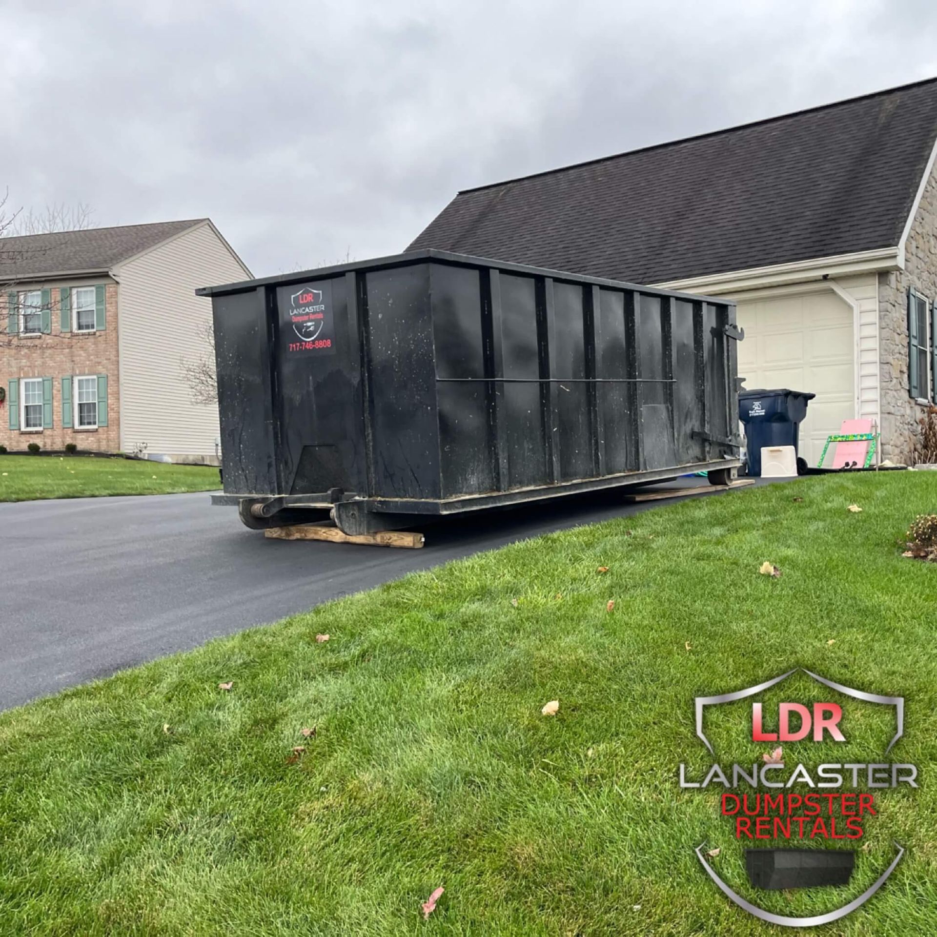 Dumpster Rental in Wrightsville Pa on a sloped driveway for a resident to use to get ready to move.