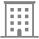 A black and white icon of a building with squares on it.