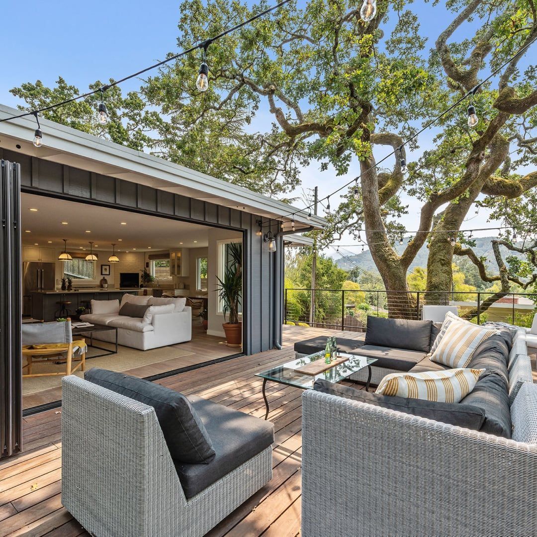 A patio with a couch , chairs , and a table.