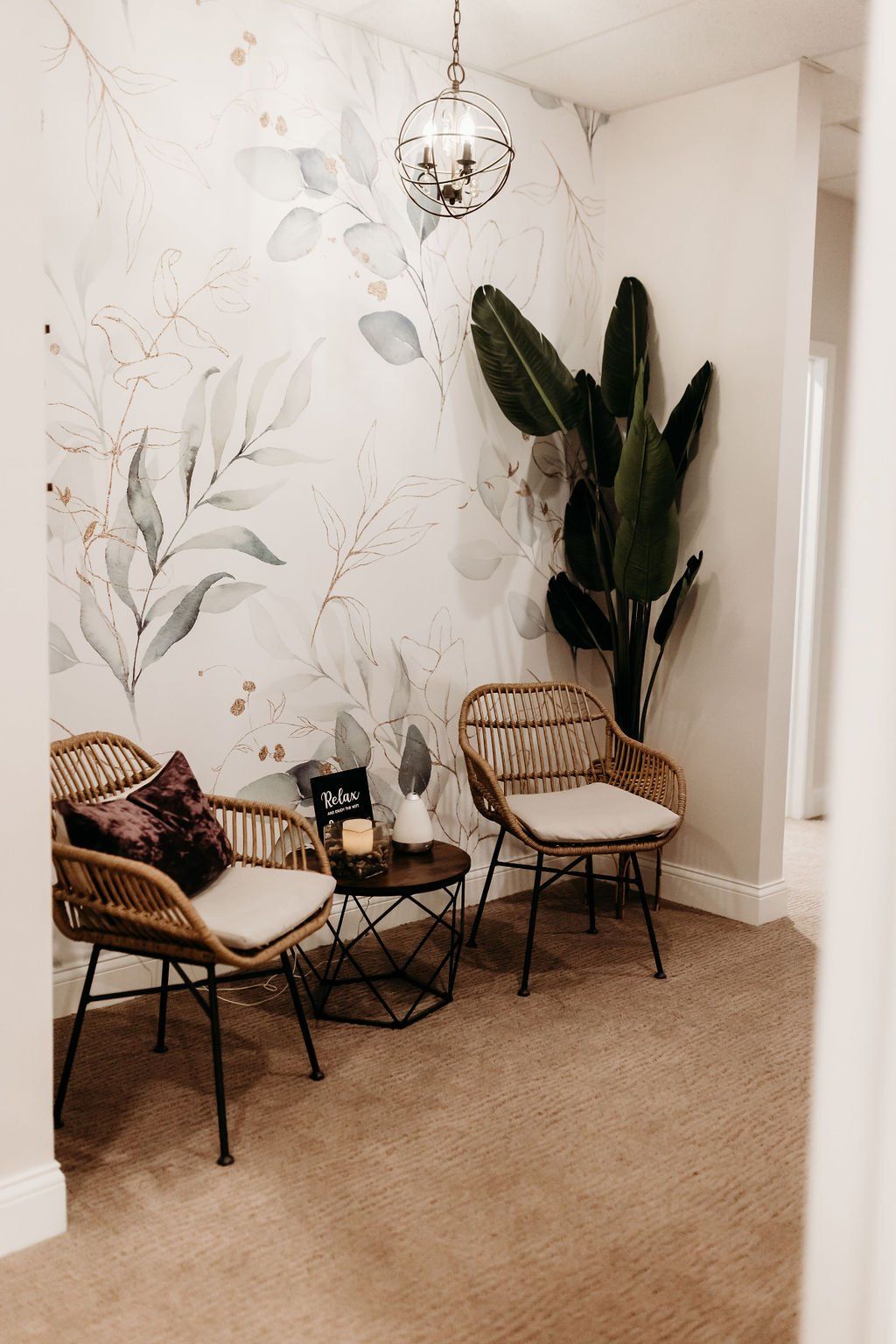 There are two chairs and a table in the room.