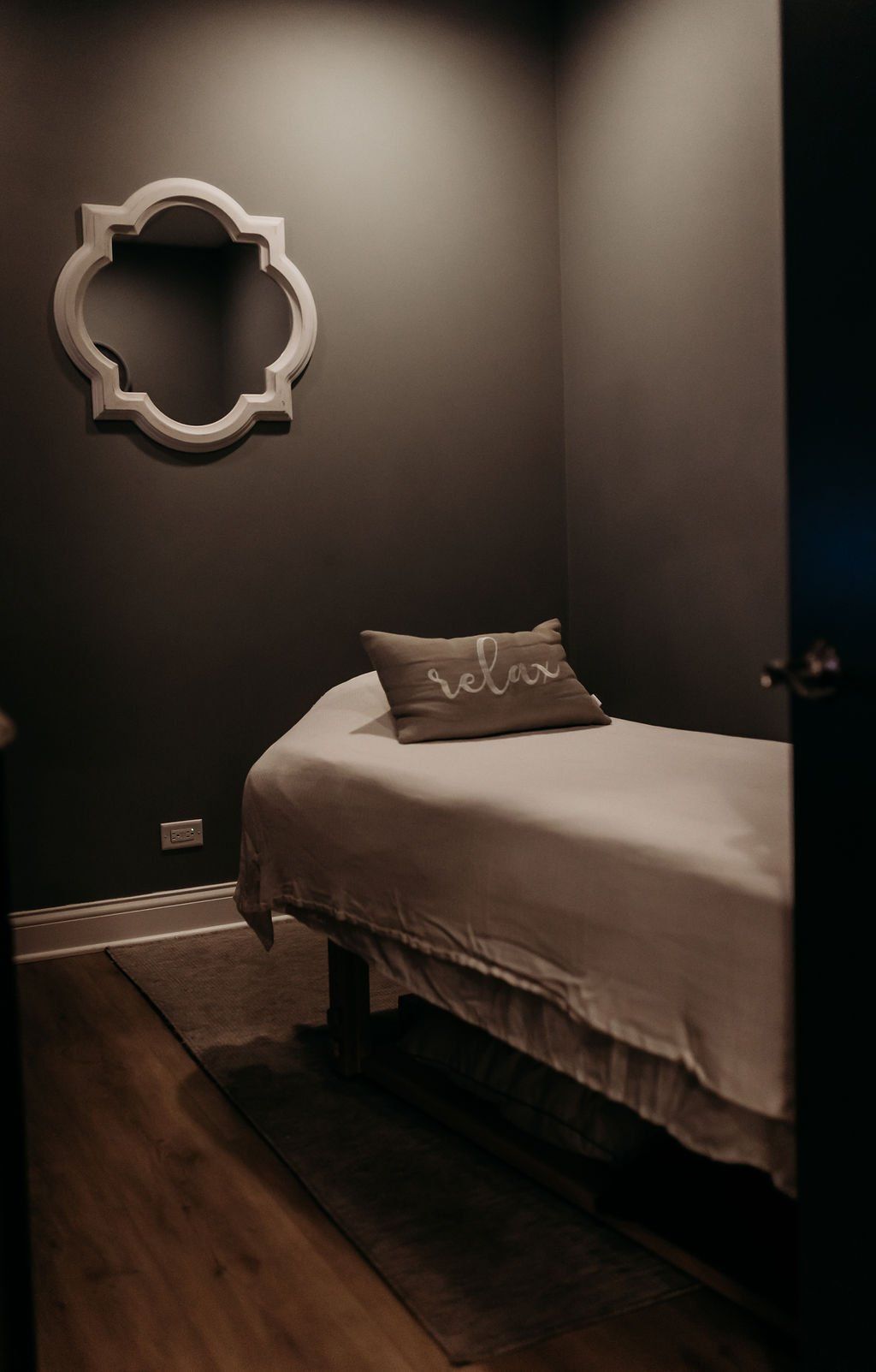 A bedroom with a bed and a mirror on the wall.