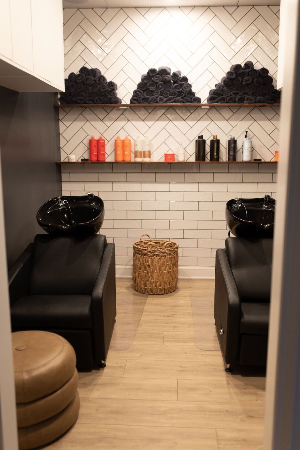 A room with two chairs and two sinks in a hair salon.