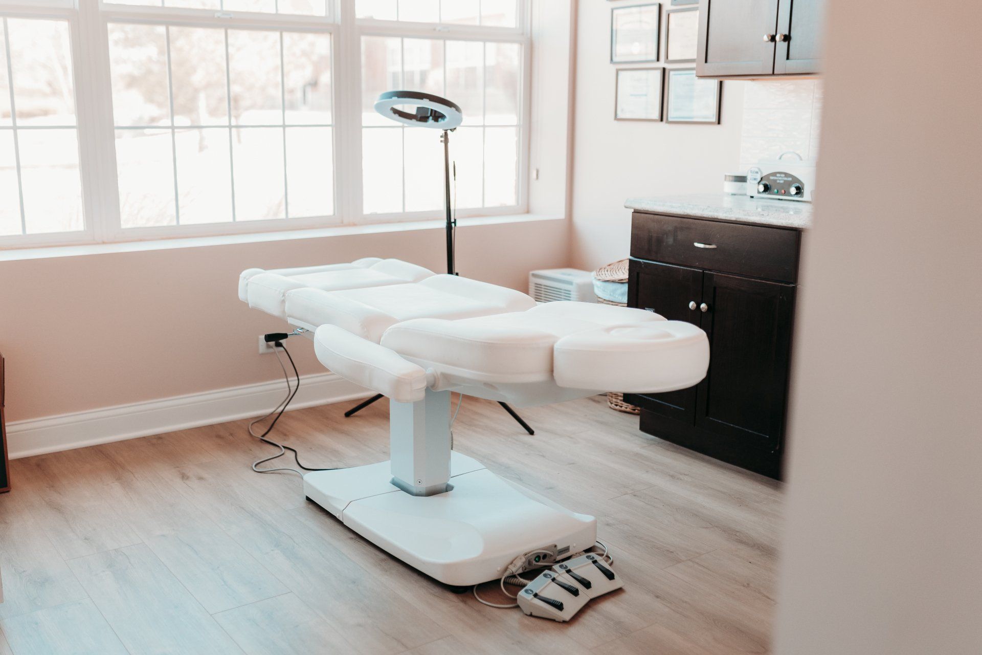 A white couch is sitting in a room next to a window.