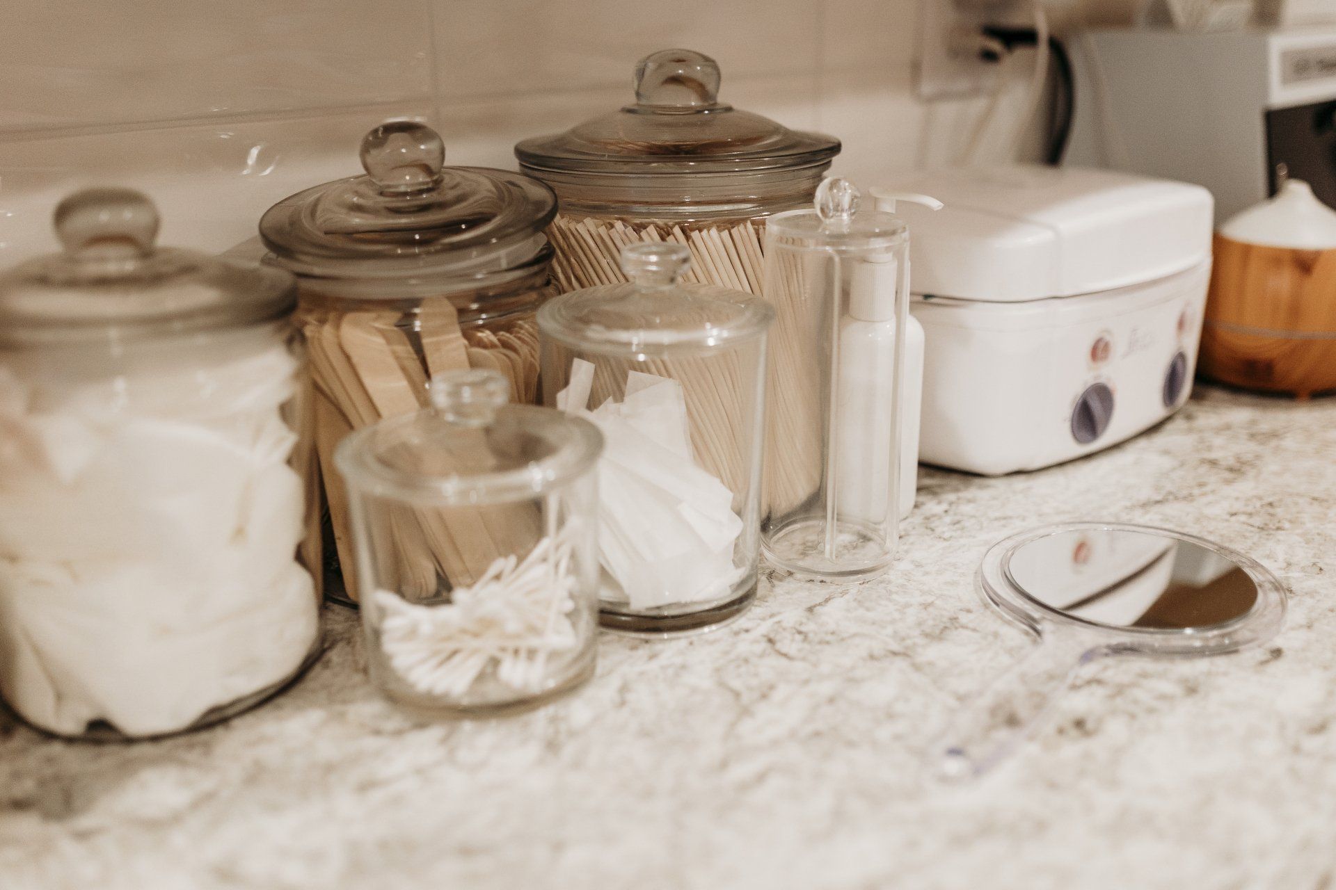 A spa counter with a lot of jars on it.