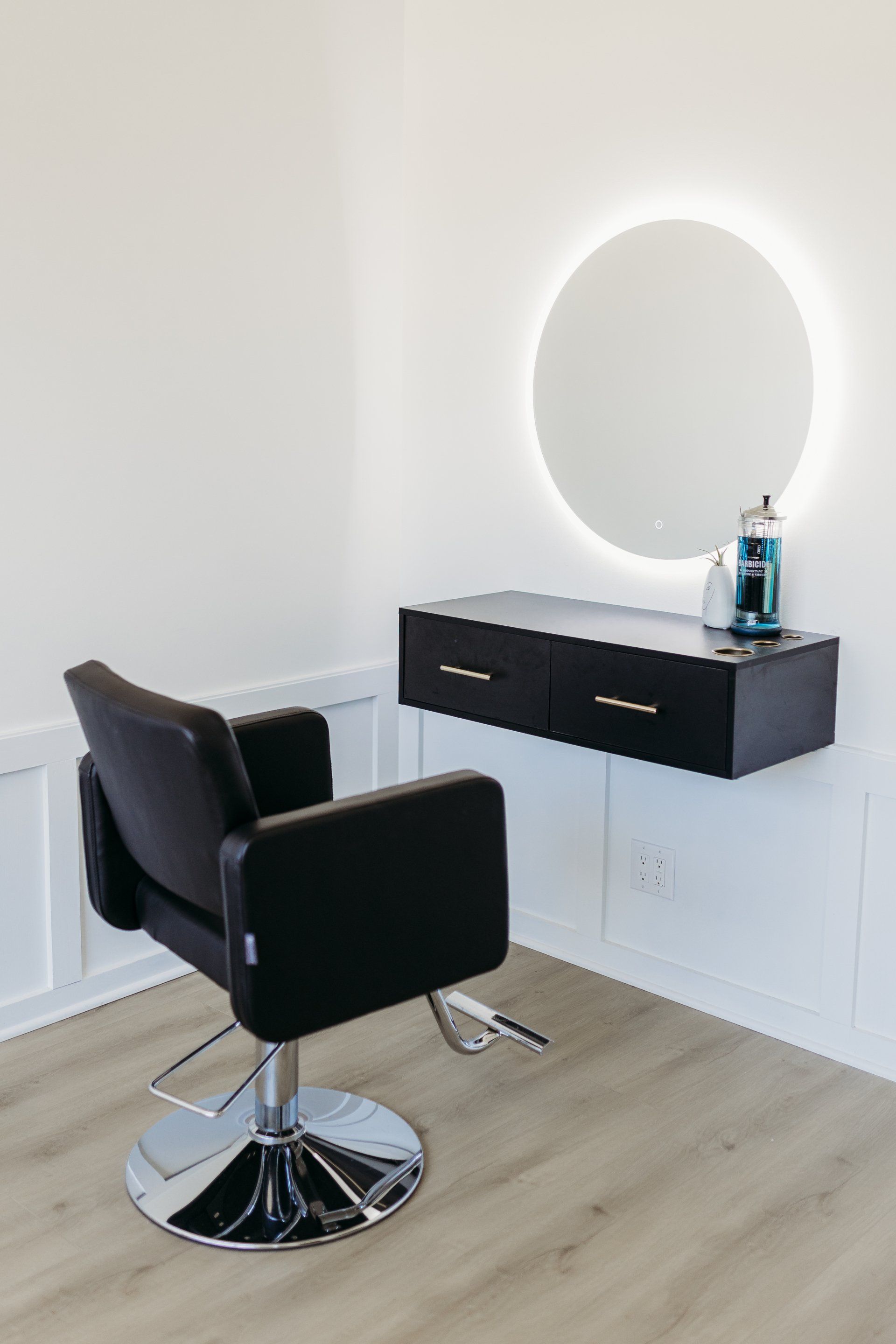 There is a chair and a mirror in the room.