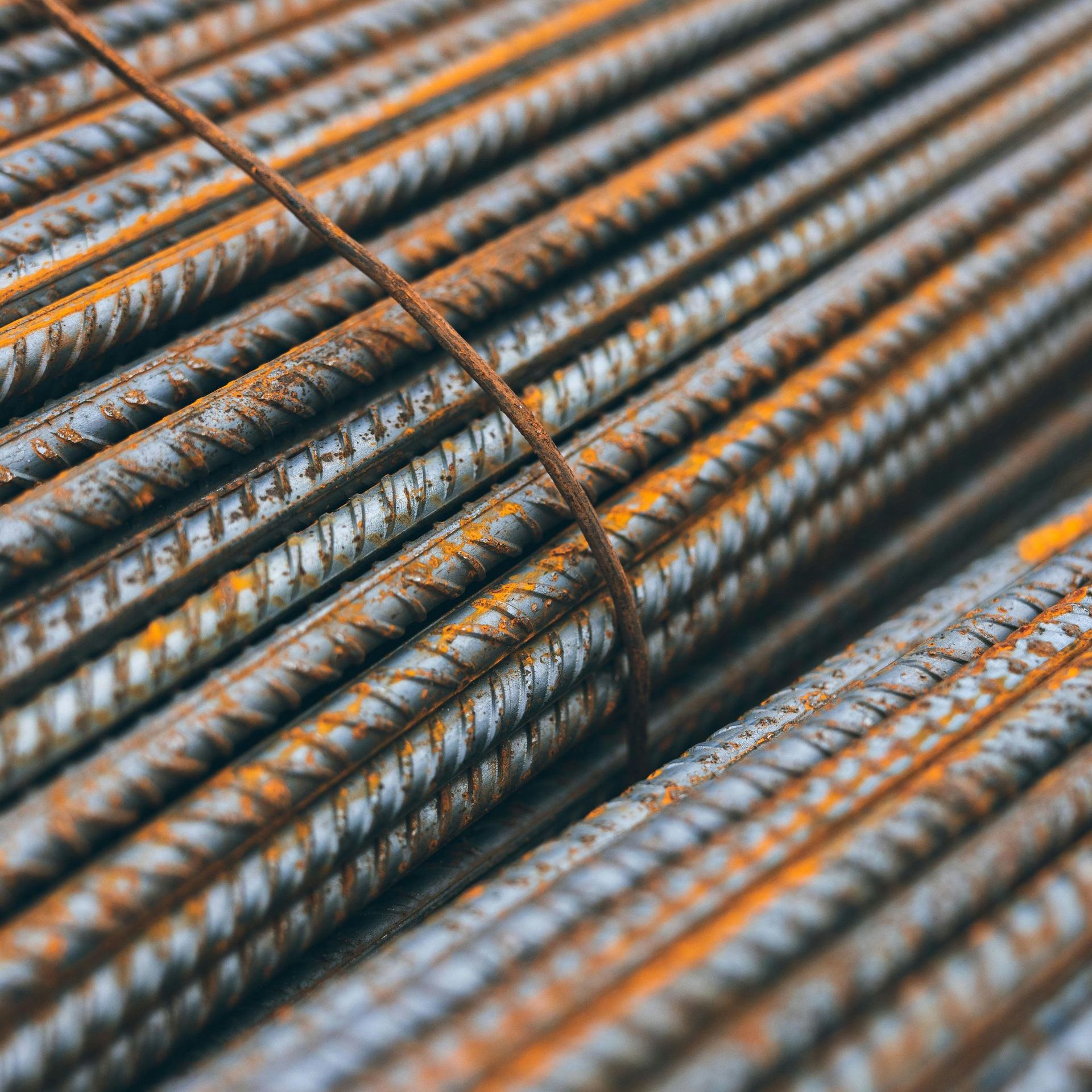 Close-up of a bundle of rusty steel rebar tied together.