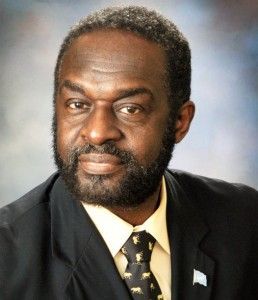 A man with a beard is wearing a suit and tie.