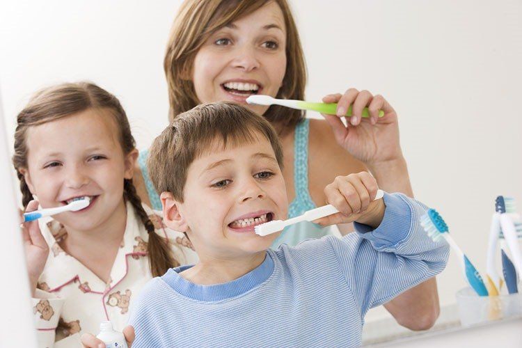 Sibling using toothbrush - Dental Care in Sumter, SC