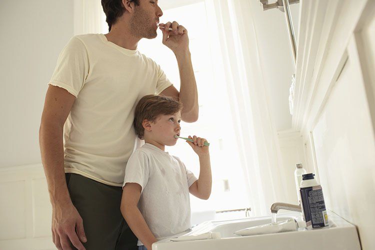 Father & son using toothbrush - Dental Care in Sumter, SC