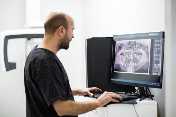 Dentist examining an X-ray.