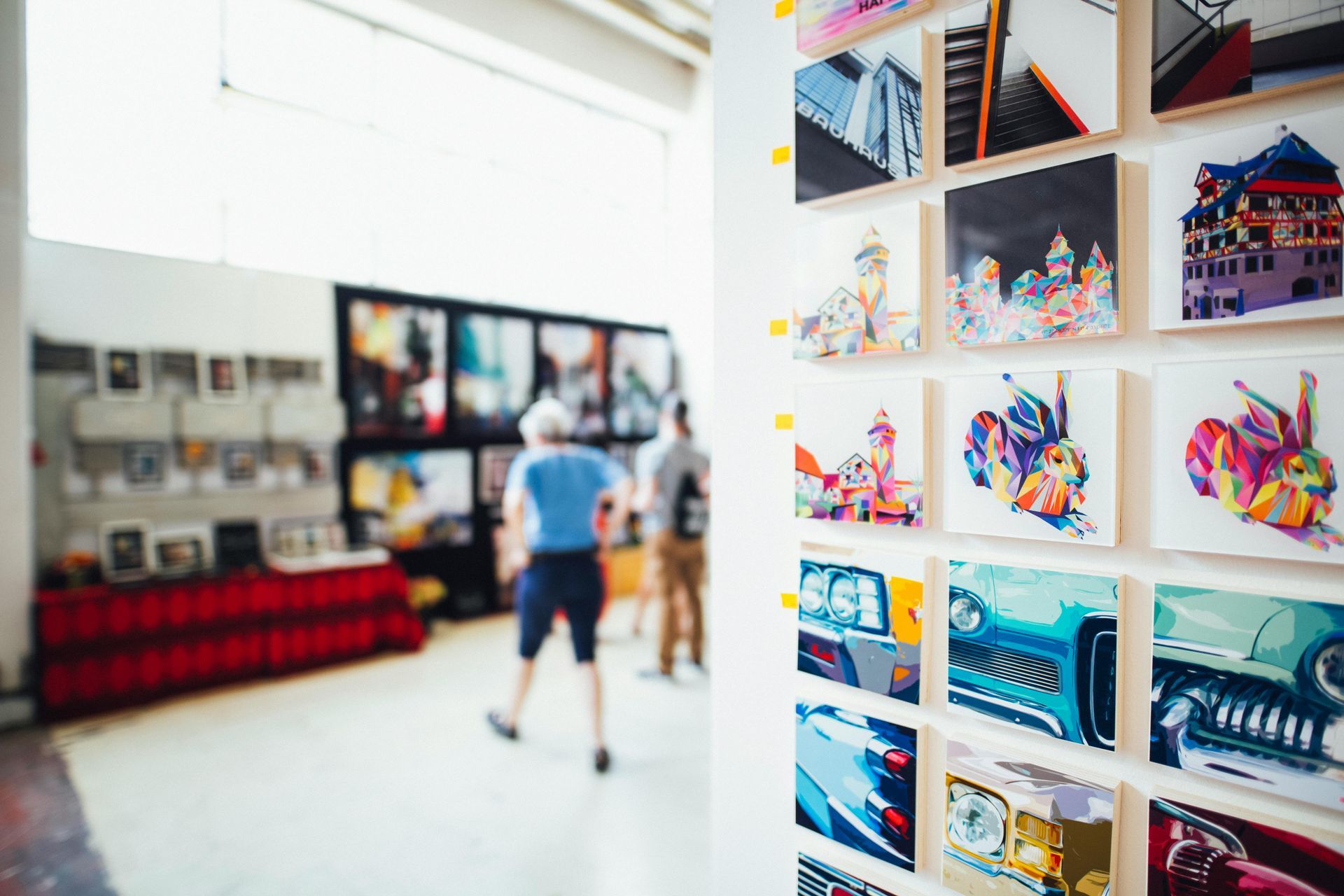 A group of people are standing in front of a wall of pictures.