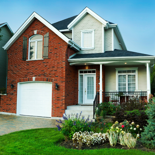 A large brick house with a white garage door
