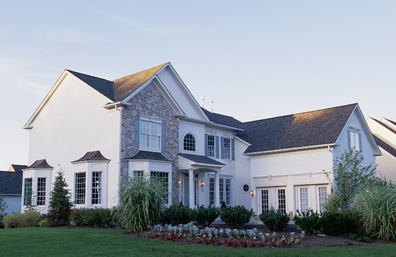A large white house with a black roof