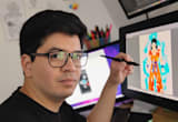 Man with glasses drawing on a digital tablet, showing a colorful character illustration.