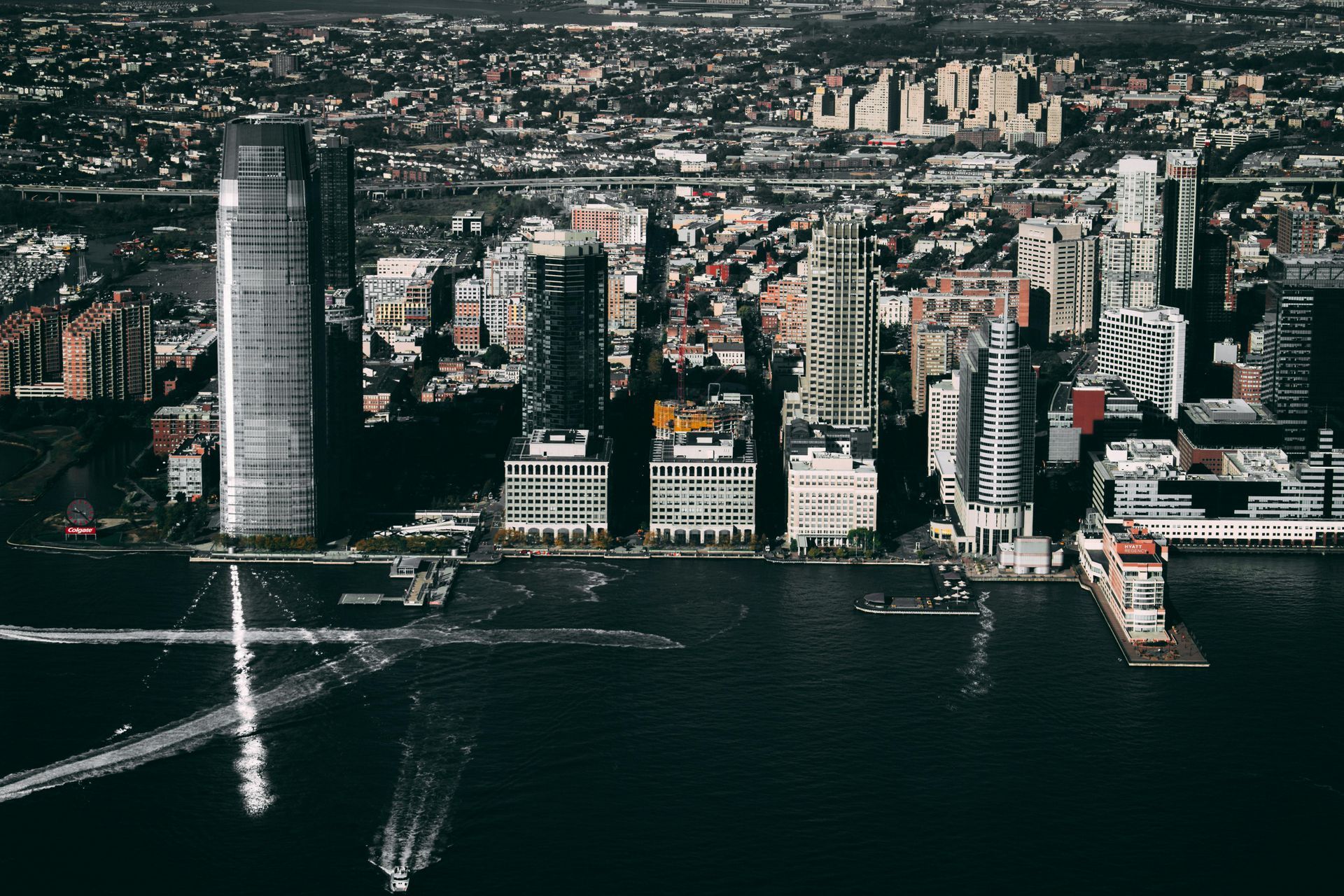 An aerial view of a city with a body of water in the foreground.