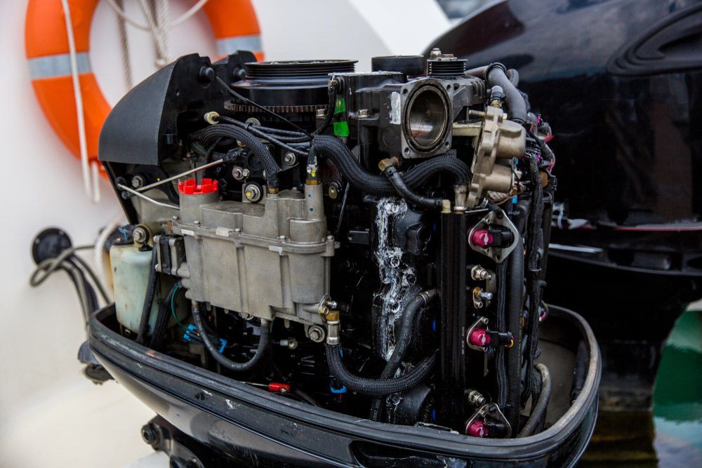 Black Boat Engine With Various Hoses — Cairns Electrical Rewinds & Repairs In Bungalow, QLD