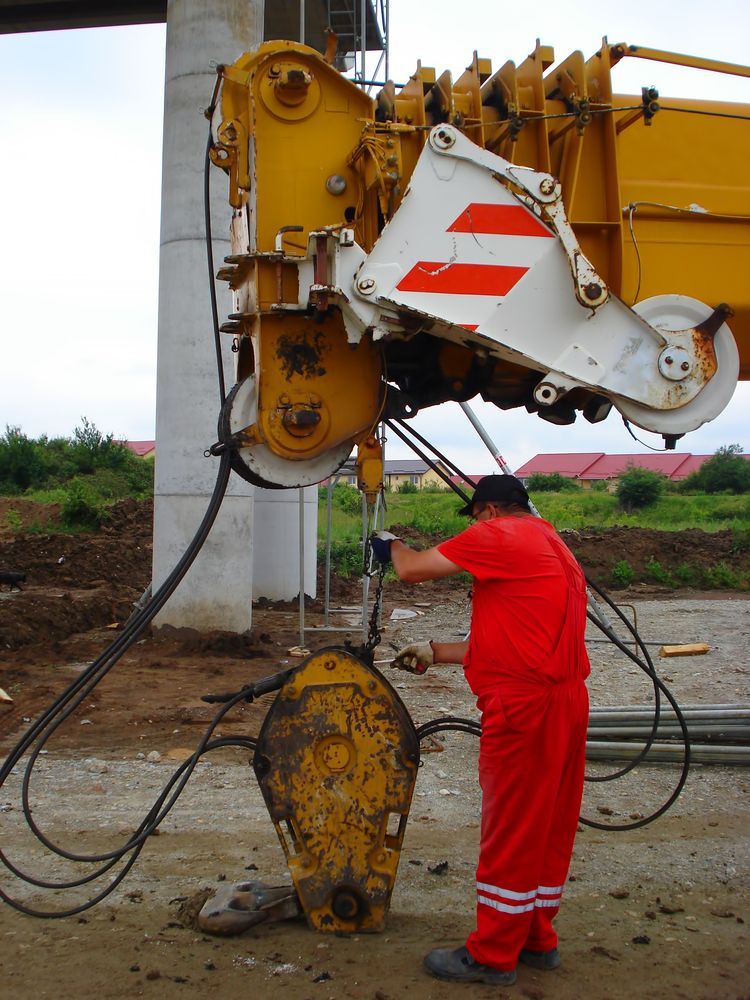 Construction Worker in Red Overalls — Cairns Electrical Rewinds & Repairs In Innisfail, QLD